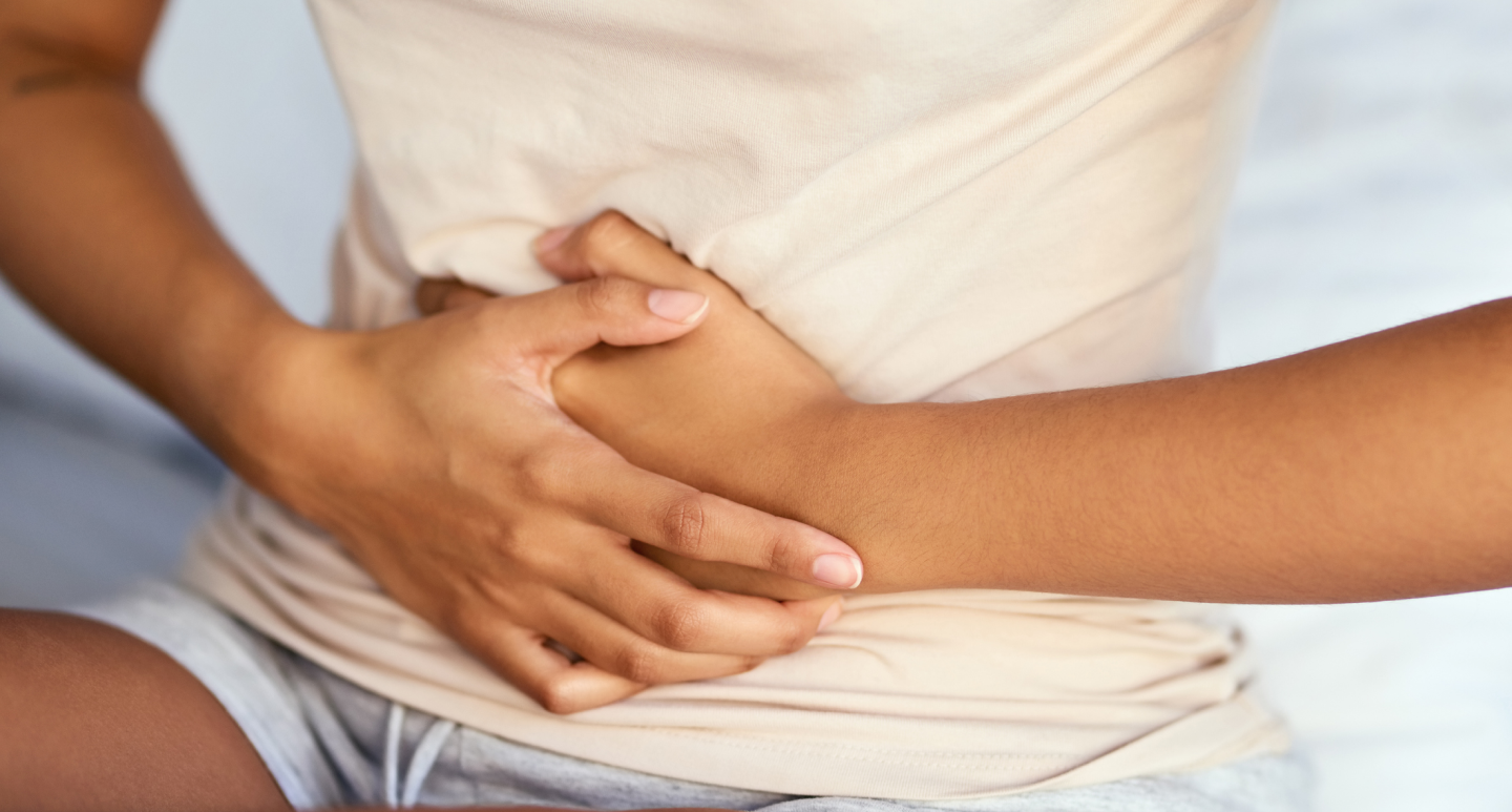 Endometriosis - woman clutching abdomen in pain